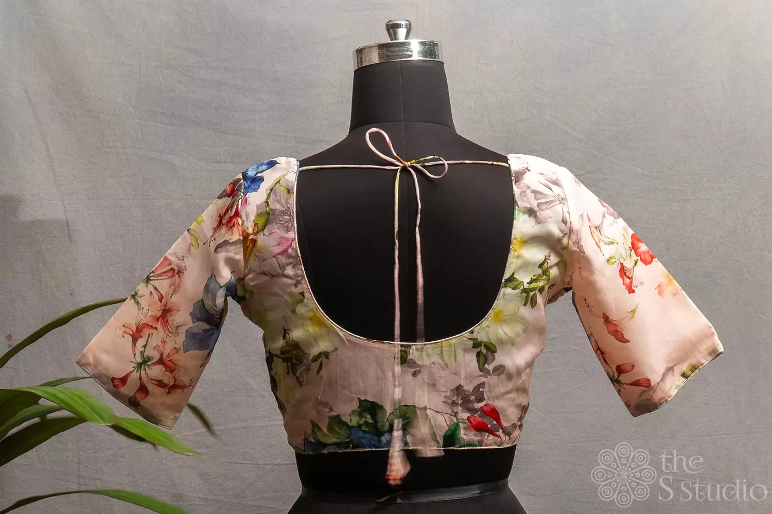 Light pink semi-silk readymade blouse with floral prints.