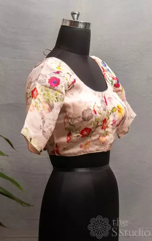 Light pink semi-silk readymade blouse with floral prints.