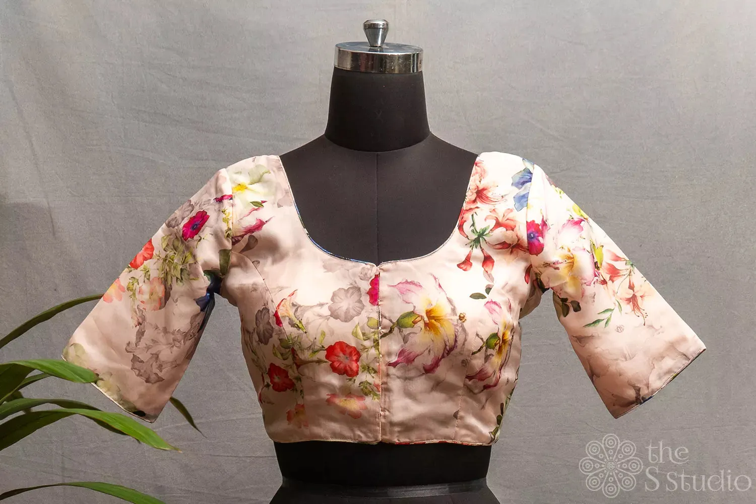 Light pink semi-silk readymade blouse with floral prints.