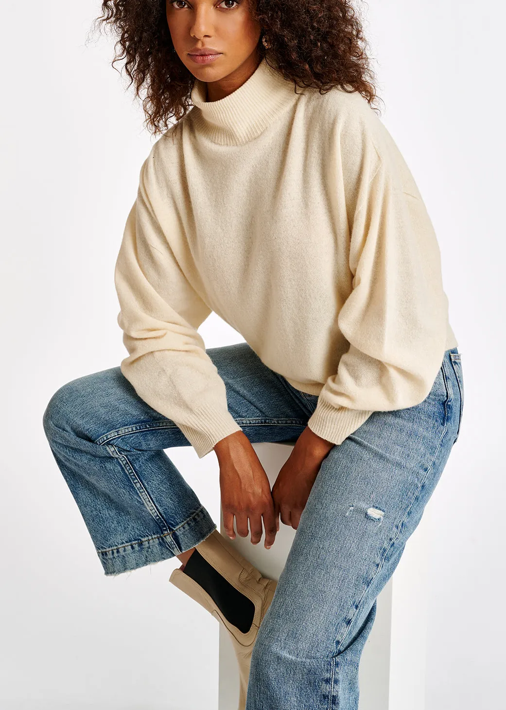 Off-white merino wool blend turtleneck sweater