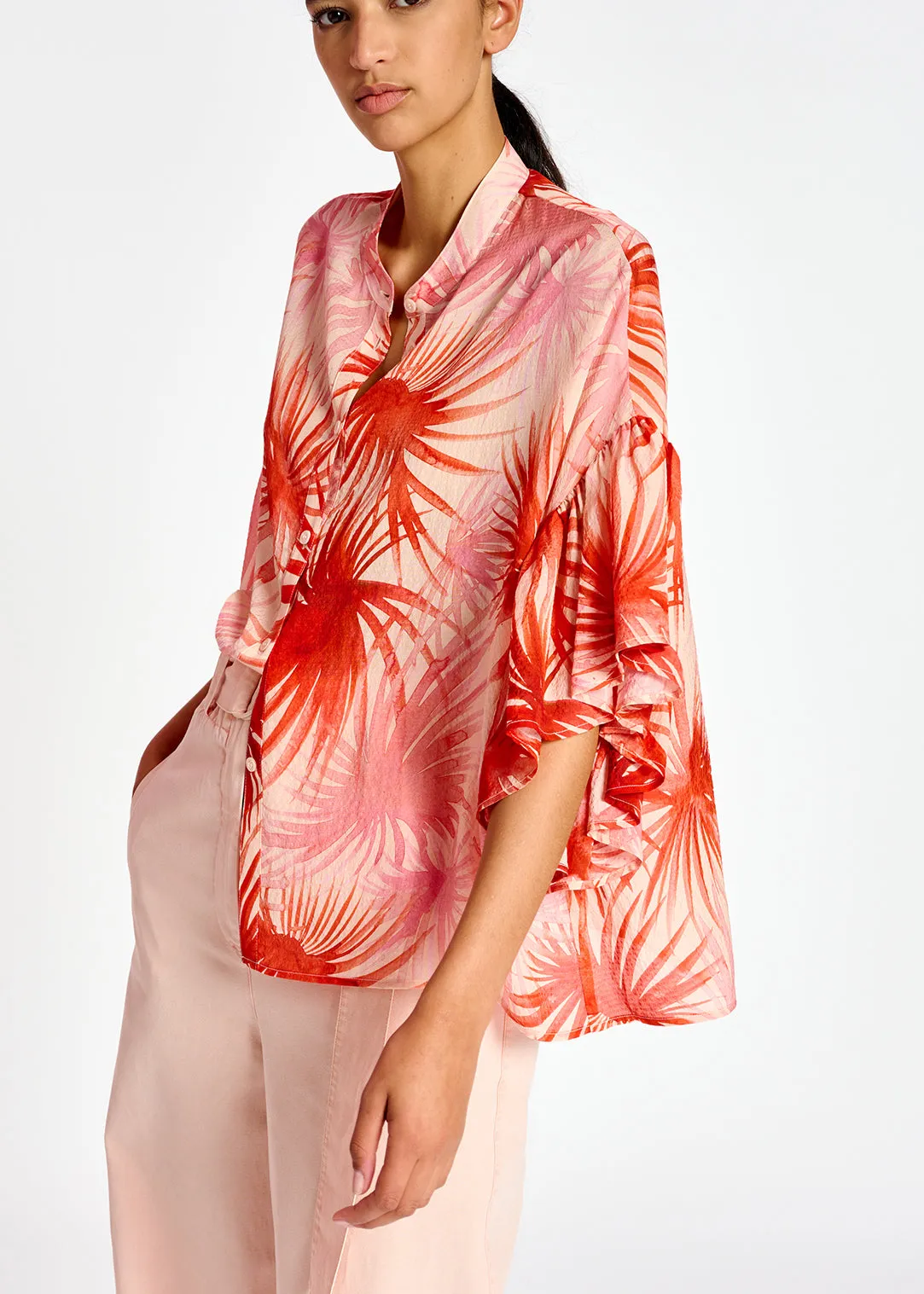 Orange ruffle-detailed top with palm leaf print