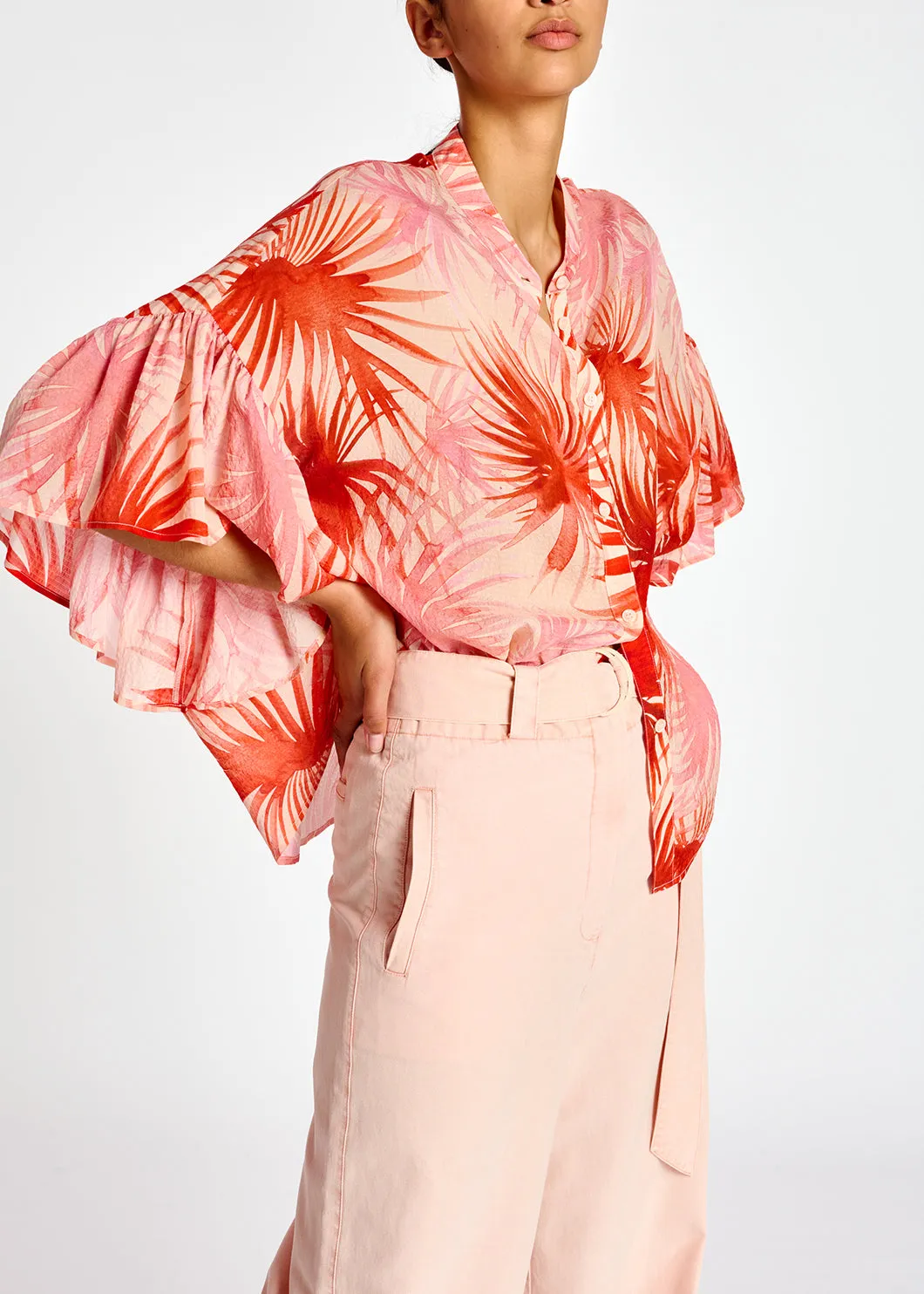 Orange ruffle-detailed top with palm leaf print
